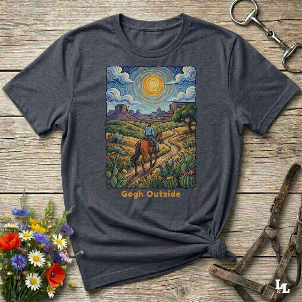 gray t-shirt with a desert scene graphic and 'Gogh Outside' text on a wooden surface with flowers and a key. Perfect gift for horse lovers.