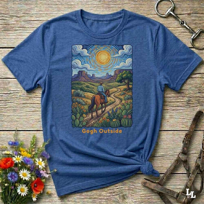 blue t-shirt with a desert scene graphic and 'Gogh Outside' text on a wooden surface with flowers and a key. Perfect gift for horse lovers.