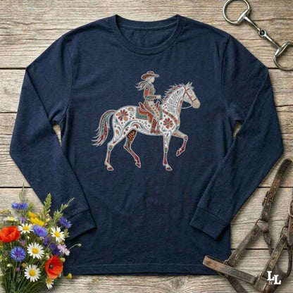Navy blue long-sleeve shirt with a colorful horse and rider design on a wooden surface with floral and equestrian accessories.