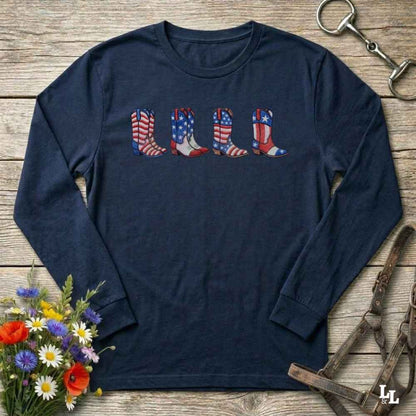 Navy long-sleeve shirt with American flag cowboy boots design on a wooden surface with floral and equestrian elements.