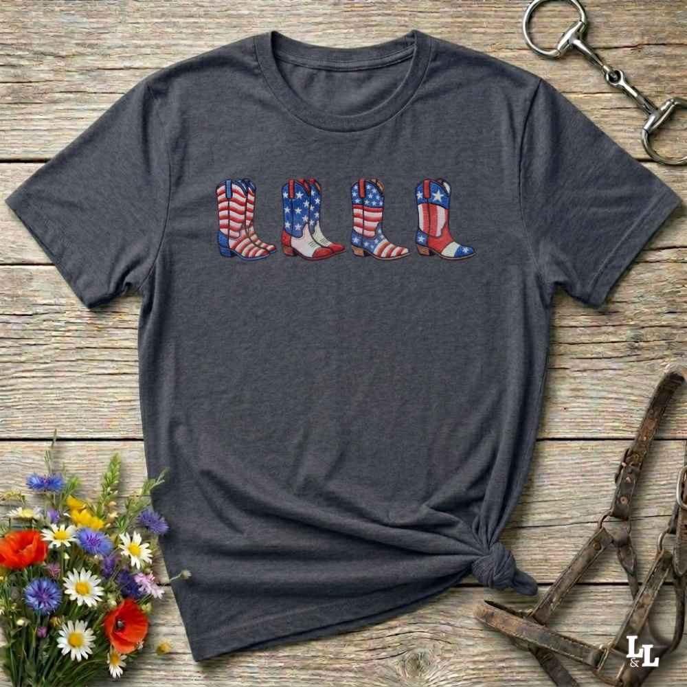 Dark gray t-shirt with 'So Many Horses .. so little time' text on a wooden surface with floral and equestrian accessories.