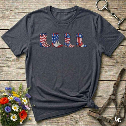 Dark gray t-shirt with 'So Many Horses .. so little time' text on a wooden surface with floral and equestrian accessories.