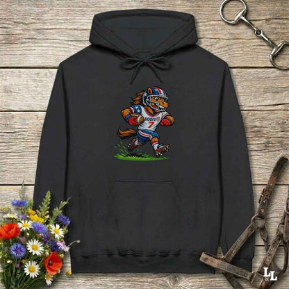 black hoodie with horse mascot playing american football, lying on wooden background with equestrian accessories