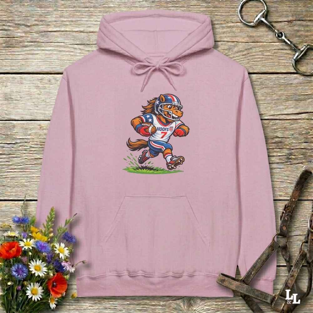 pink hoodie with horse mascot playing american football, lying on wooden background with equestrian accessories