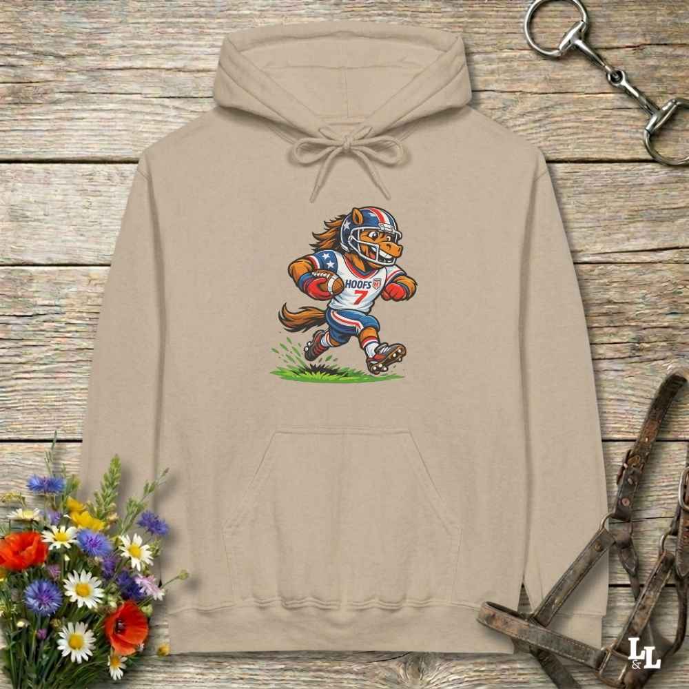 beige  hoodie with horse mascot playing american football, lying on wooden background with equestrian accessories