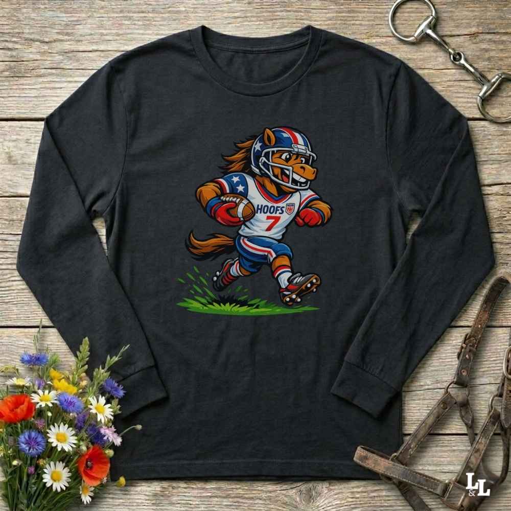 black  long-sleeve shirt with a cartoon horse in a american football uniform on a wooden surface with flowers and a horse halter and bit.