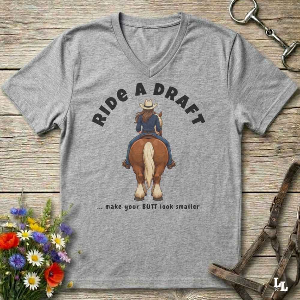 A heather gray V-neck t-shirt with a graphic of a cowboy riding a brown horse, with the text 'RIDE A DRAFT .
