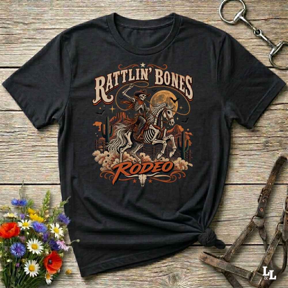 black t-shirt with short sleeves, with halloween design of rattlin'bones rodeo, with skull cowboy riding a horse in the desert
