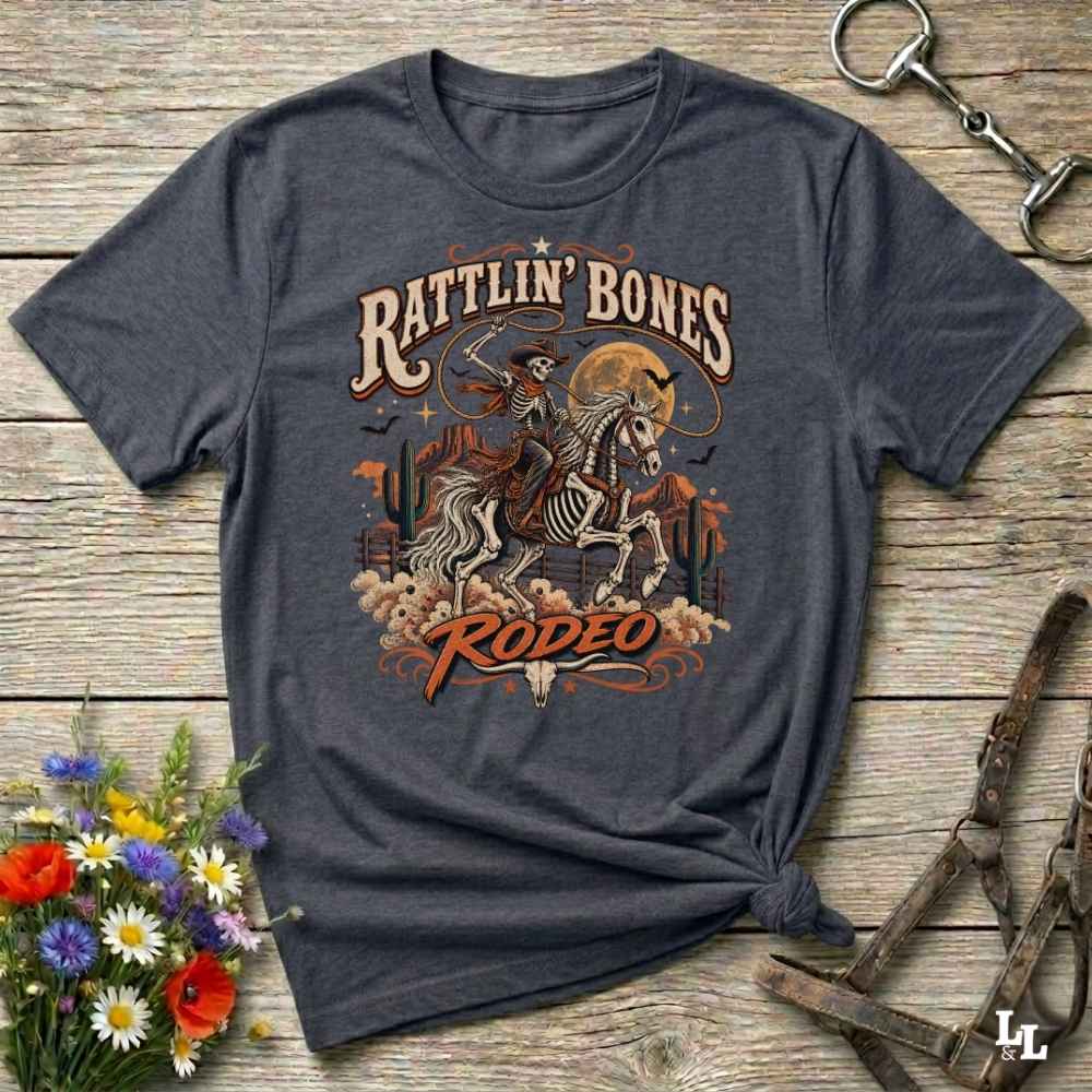 grey t-shirt with short sleeves, with halloween design of rattlin'bones rodeo, with skull cowboy riding a horse in the desert