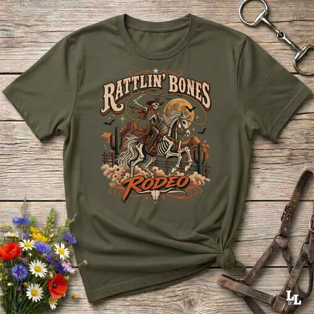green t-shirt with short sleeves, with halloween design of rattlin'bones rodeo, with skull cowboy riding a horse in the desert