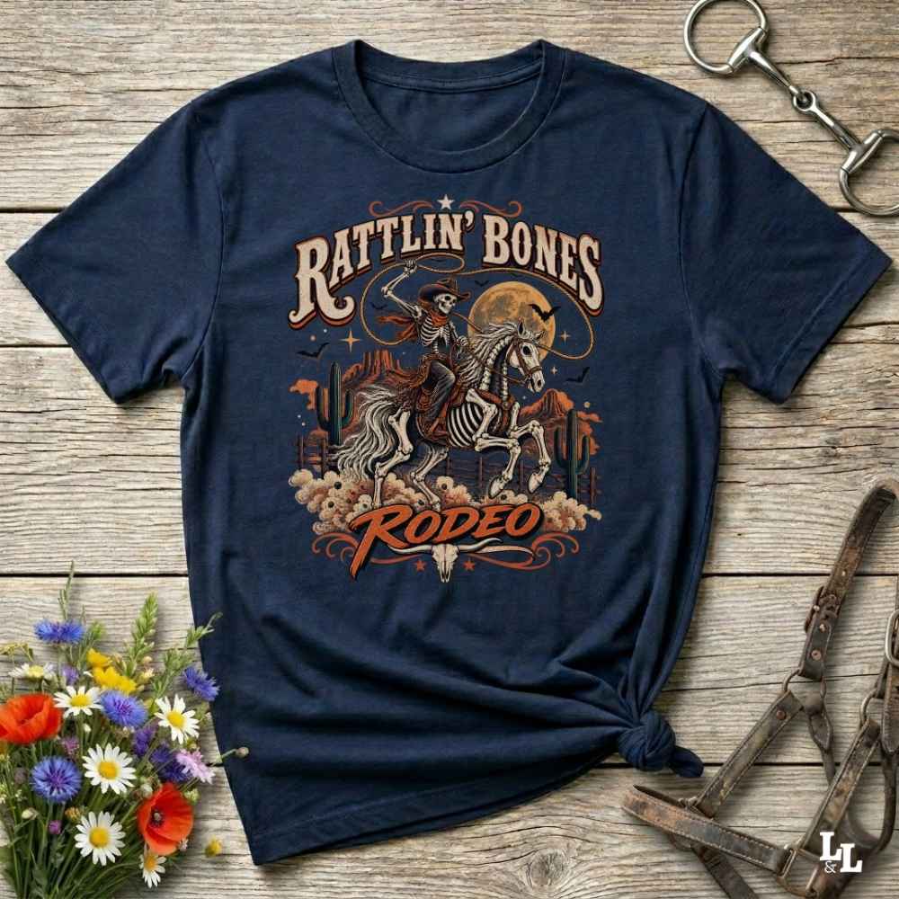Blue t-shirt with short sleeves, with halloween design of rattlin'bones rodeo, with skull cowboy riding a horse in the desert