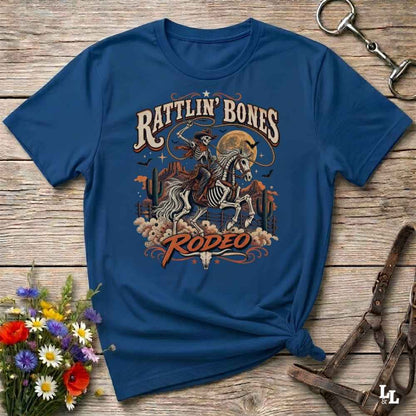 Blue t-shirt with short sleeves, with halloween design of rattlin'bones rodeo, with skull cowboy riding a horse in the desert