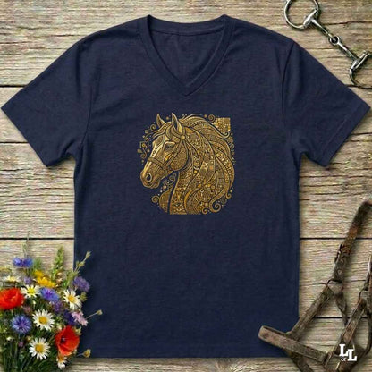 A navy blue V-neck t-shirt with a detailed gold horse head graphic on the chest, styled in a flat-lay on a rustic wooden background with equestrian accessories and flowers.
