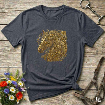 A dark heather gray t-shirt with a gold horse head graphic, styled flat on a rustic wooden background with equestrian accessories and flowers.