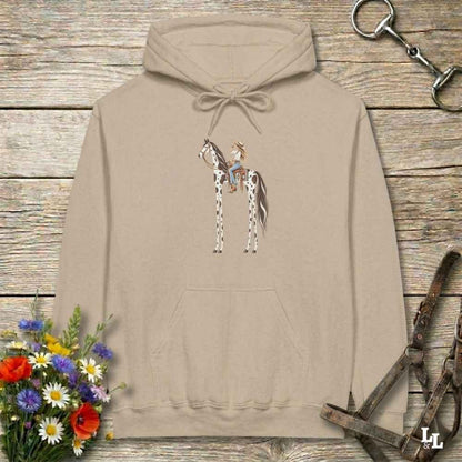 A beige pullover hoodie with a graphic of a cowboy riding a horse, displayed on a rustic wooden background with equestrian-themed props like a halter, reins, and a small bouquet of wildflowers.