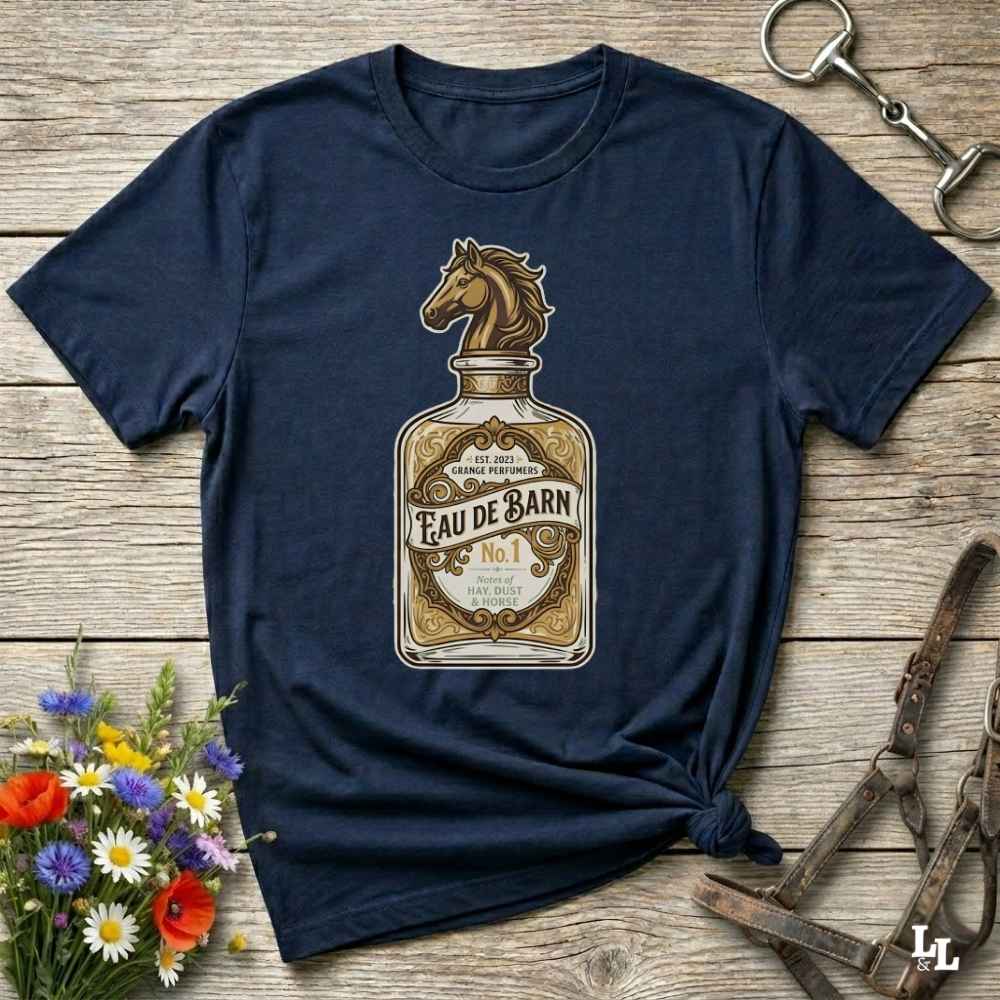 A navy blue short-sleeve t-shirt with a graphic print of a perfume bottle featuring a horse head and the text 'Feau de Barn No. 1'.