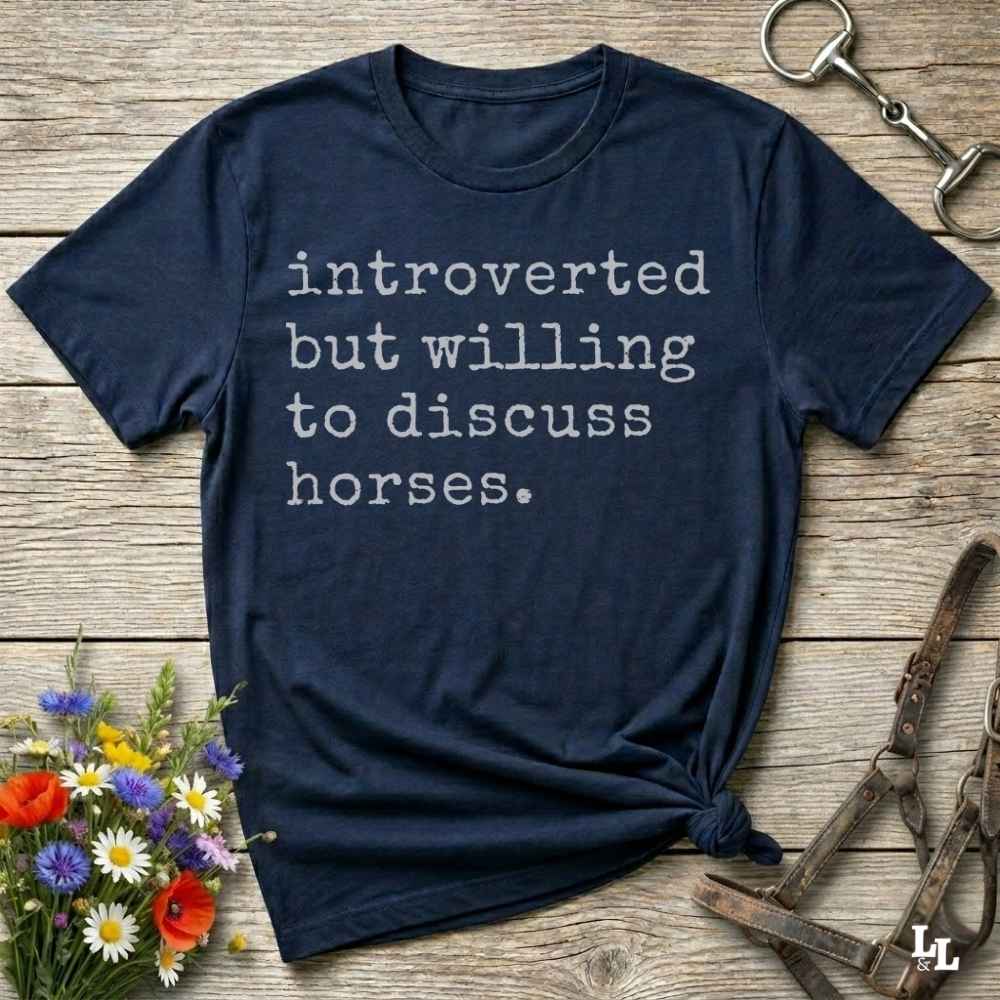 navy blue Funny horse lover t-shirt that reads ‘Introverted but willing to discuss horses’ in western typography