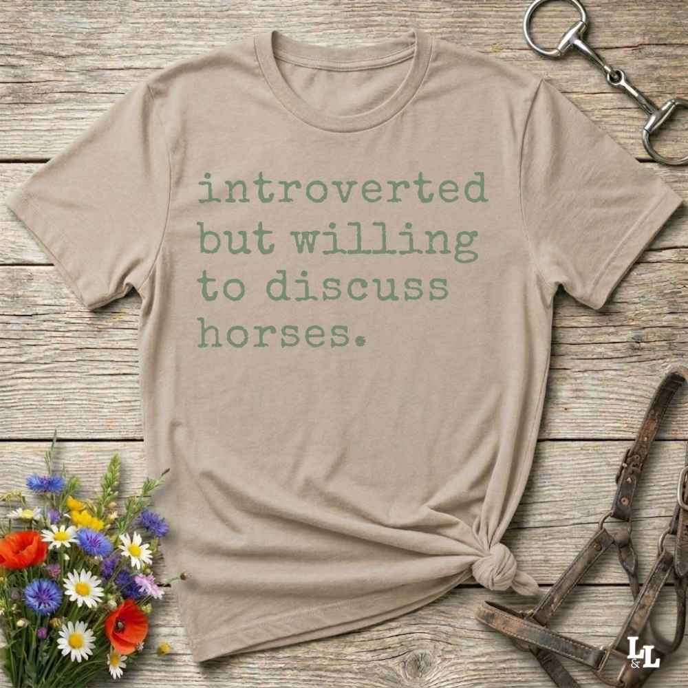 beige Funny horse lover t-shirt that reads ‘Introverted but willing to discuss horses’ in western typography