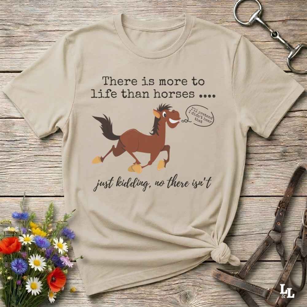 A beige graphic t-shirt featuring a brown cartoon horse and the text 'There is more to life than horses .