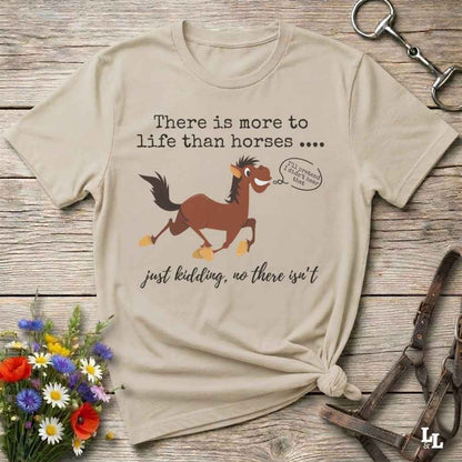A beige graphic t-shirt featuring a brown cartoon horse and the text 'There is more to life than horses .