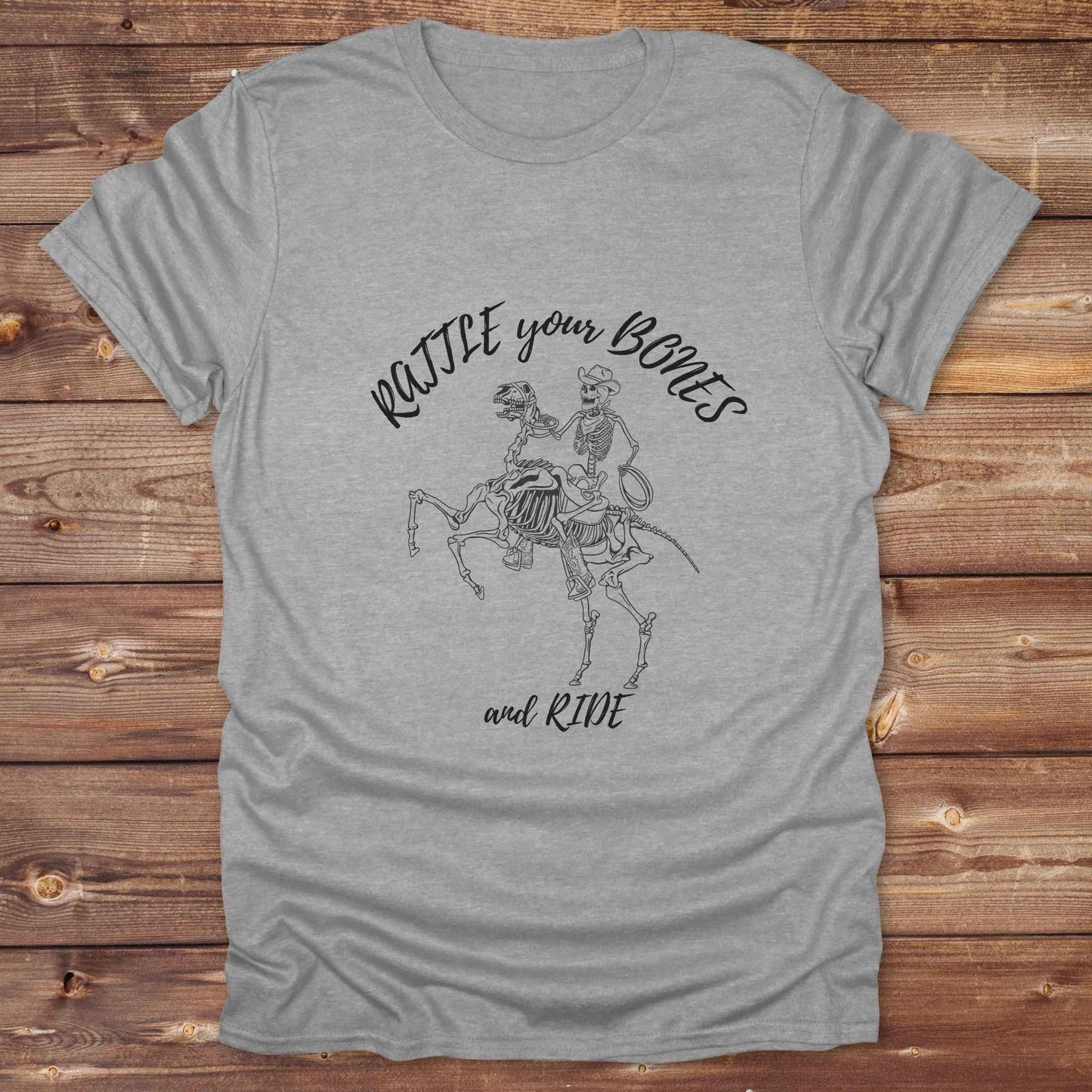 Fun western t-shirt featuring horse themed design for cowgirls, cowboys, horse lovers and equestrians, perfect for rodeo lovers, rustic style fans, and horse people. Unique graphic tee by Lasso and Loom.  Rattle your bones and ride.
