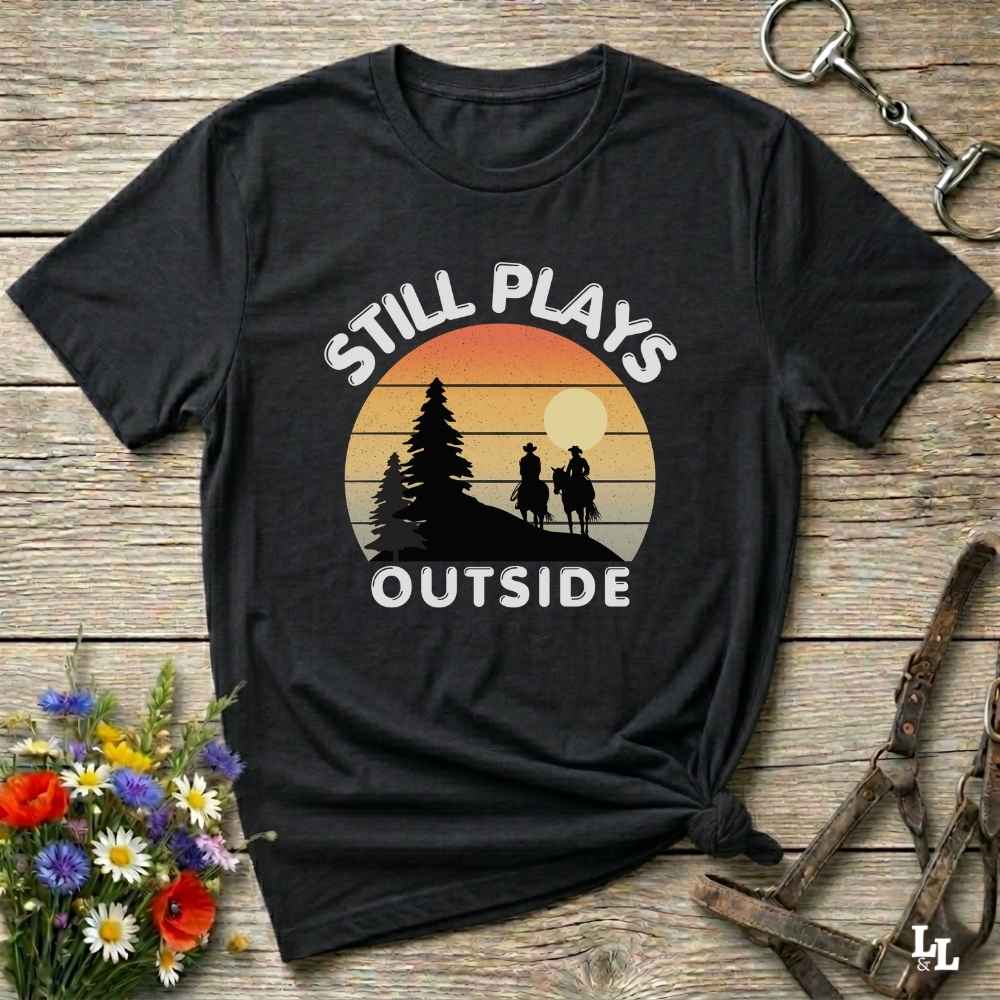 Still plays outside. Funny western t-shirt featuring horse-themed design for cowgirls, cowboys, and equestrians — perfect for rodeo lovers, rustic style fans, and horse people. Unique graphic tee by Lasso and Loom.