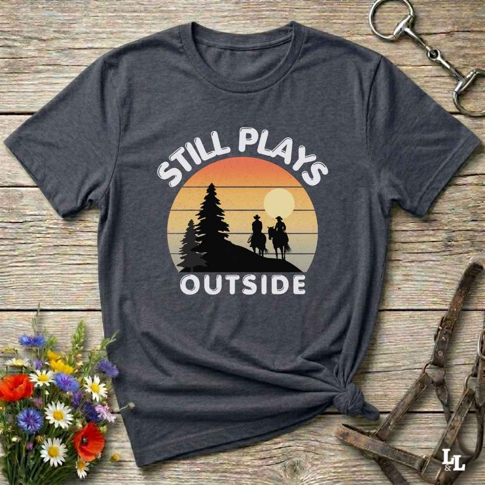 Still plays outside. Funny western t-shirt featuring horse-themed design for cowgirls, cowboys, and equestrians — perfect for rodeo lovers, rustic style fans, and horse people. Unique graphic tee by Lasso and Loom.