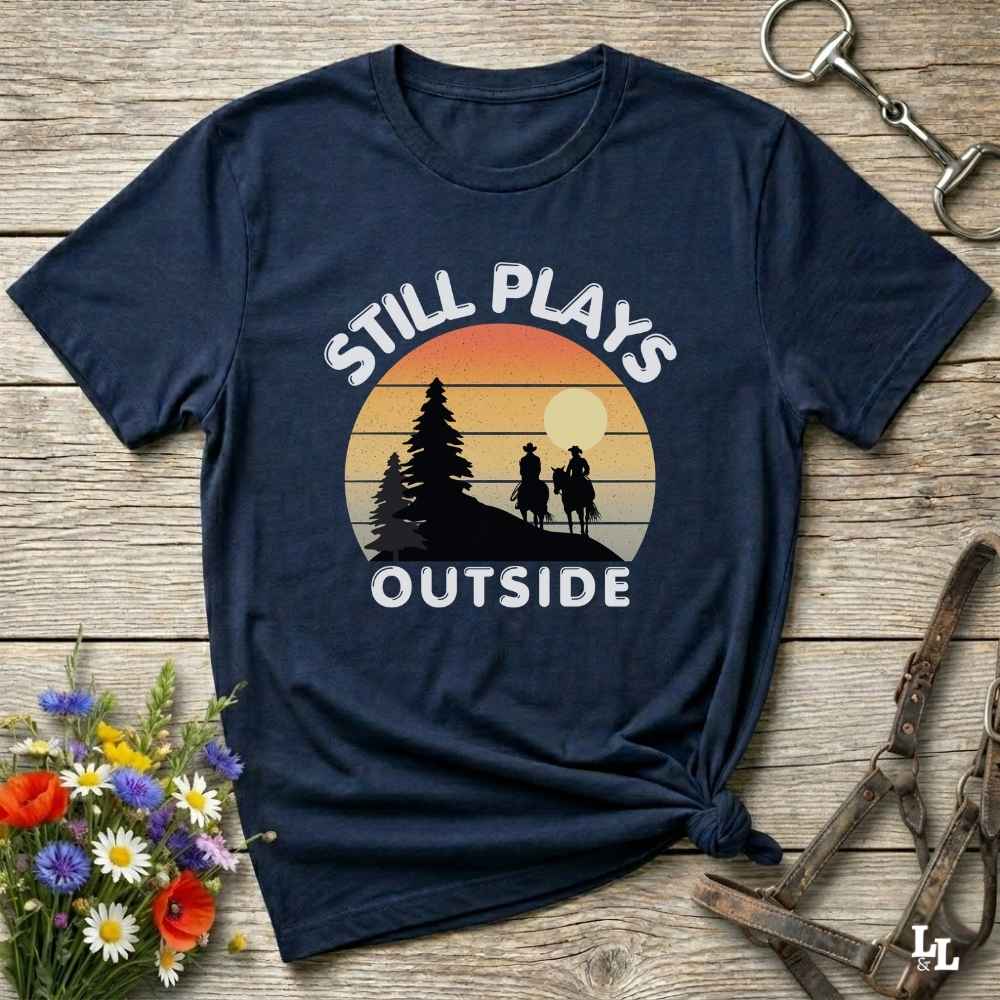 Still plays outside. Funny western t-shirt featuring horse-themed design for cowgirls, cowboys, and equestrians — perfect for rodeo lovers, rustic style fans, and horse people. Unique graphic tee by Lasso and Loom.