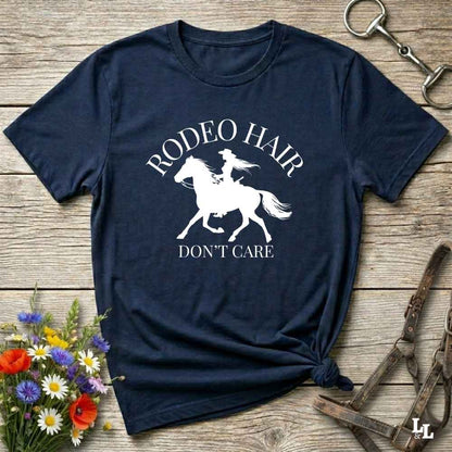 typography cowgirl t-shirt styled for rodeo lovers and horse girls on rustic wooden background. Trendy cowgirl shirt designed for horse lovers, featuring bold western lettering in graphic style. Horse riding themed t-shirt with country slogan “Rodeo Hair Don’t Care” styled for modern cowgirls.