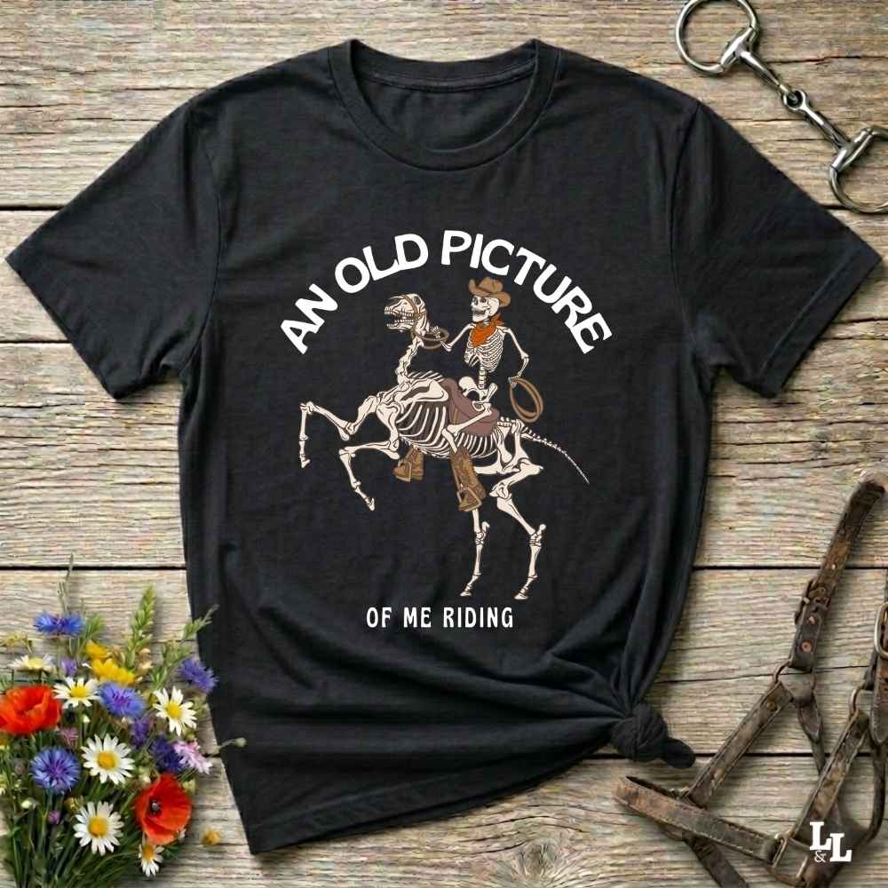Saddle up with spooky western vibes in this skeleton cowboy “Old Picture of Me Riding” shirt, perfect for rodeo lovers and Halloween humor fans. This cowboy skeleton t-shirt combines retro western style with dark humor, ideal for ranchers, riders, and funny costume alternatives. Make fall fashion unforgettable with this witty, rustic western parody tee featuring bones, boots, and bold cowboy nostalgia.