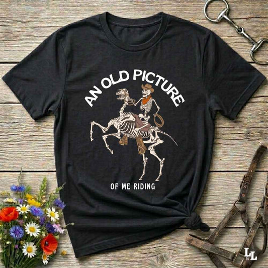 Saddle up with spooky western vibes in this skeleton cowboy “Old Picture of Me Riding” shirt, perfect for rodeo lovers and Halloween humor fans. This cowboy skeleton t-shirt combines retro western style with dark humor, ideal for ranchers, riders, and funny costume alternatives. Make fall fashion unforgettable with this witty, rustic western parody tee featuring bones, boots, and bold cowboy nostalgia.