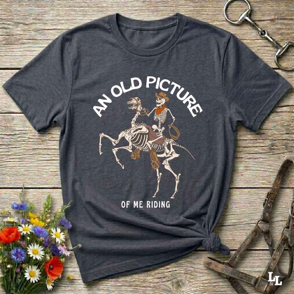Saddle up with spooky western vibes in this skeleton cowboy “Old Picture of Me Riding” shirt, perfect for rodeo lovers and Halloween humor fans. This cowboy skeleton t-shirt combines retro western style with dark humor, ideal for ranchers, riders, and funny costume alternatives. Make fall fashion unforgettable with this witty, rustic western parody tee featuring bones, boots, and bold cowboy nostalgia.