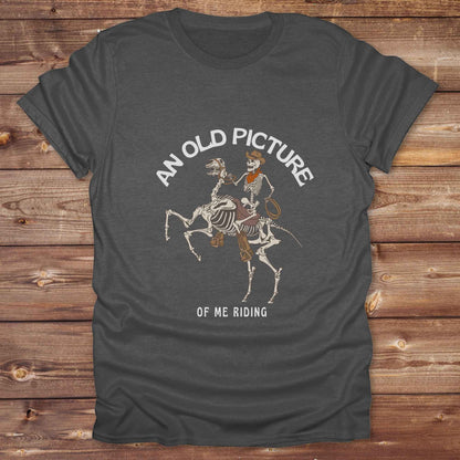 Saddle up with spooky western vibes in this skeleton cowboy “Old Picture of Me Riding” shirt, perfect for rodeo lovers and Halloween humor fans. This cowboy skeleton t-shirt combines retro western style with dark humor, ideal for ranchers, riders, and funny costume alternatives. Make fall fashion unforgettable with this witty, rustic western parody tee featuring bones, boots, and bold cowboy nostalgia.