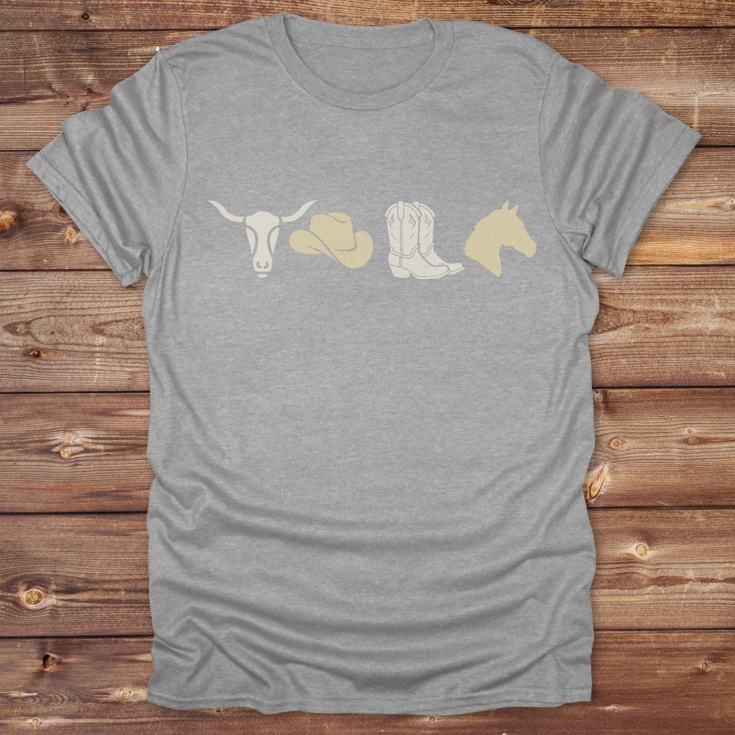 Embrace western vibes with this boho inspired graphic tee, featuring cowboy icons and perfect for horse lovers and rodeo fans. Designed for cowgirls, cowboys, and equestrian souls, Whether you're headed to the rodeo or relaxing at the ranch, this cowboy hat and boots tee adds a bold country aesthetic. Featuring a longhorn skull, cowboy hat, cowboy boots and horse.