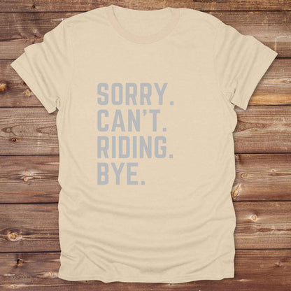 This “Sorry Can’t. Riding. Bye.” western typography tee is the perfect gift for horse lovers, trail riders, and anyone living the cowboy or cowgirl lifestyle. Made from premium Gildan 64000 cotton, it's unisex and available in 8 colors to match your cowboy core aesthetic. Whether you're off to a rodeo, riding horses, or just showing off your rustic humor, this bold minimalist horse quote shirt delivers personality and comfort. Great for birthdays, western lovers, and equestrian fashion fans.