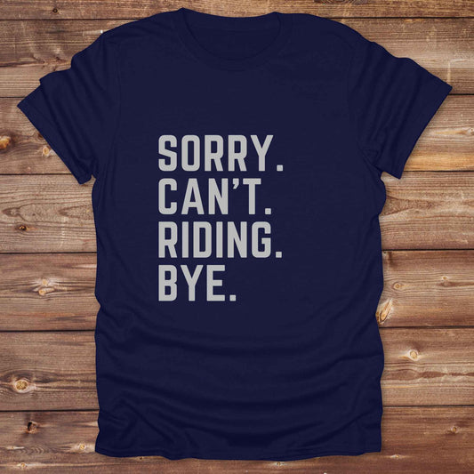 This “Sorry Can’t. Riding. Bye.” western typography tee is the perfect gift for horse lovers, trail riders, and anyone living the cowboy or cowgirl lifestyle. Made from premium Gildan 64000 cotton, it's unisex and available in 8 colors to match your cowboy core aesthetic. Whether you're off to a rodeo, riding horses, or just showing off your rustic humor, this bold minimalist horse quote shirt delivers personality and comfort. Great for birthdays, western lovers, and equestrian fashion fans.