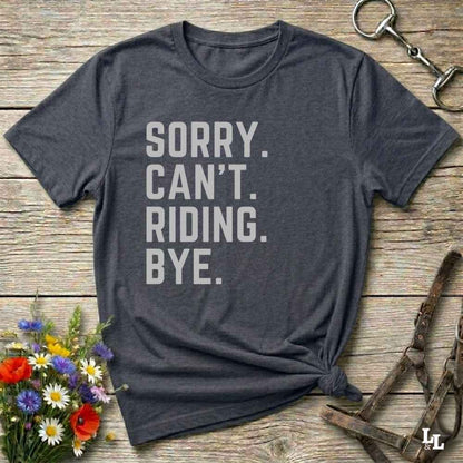 This “Sorry Can’t. Riding. Bye.” western typography tee is the perfect gift for horse lovers, trail riders, and anyone living the cowboy or cowgirl lifestyle. Made from premium Gildan 64000 cotton, it's unisex and available in 8 colors to match your cowboy core aesthetic. Whether you're off to a rodeo, riding horses, or just showing off your rustic humor, this bold minimalist horse quote shirt delivers personality and comfort. Great for birthdays, western lovers, and equestrian fashion fans.