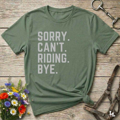 This “Sorry Can’t. Riding. Bye.” western typography tee is the perfect gift for horse lovers, trail riders, and anyone living the cowboy or cowgirl lifestyle. Made from premium Gildan 64000 cotton, it's unisex and available in 8 colors to match your cowboy core aesthetic. Whether you're off to a rodeo, riding horses, or just showing off your rustic humor, this bold minimalist horse quote shirt delivers personality and comfort. Great for birthdays, western lovers, and equestrian fashion fans.