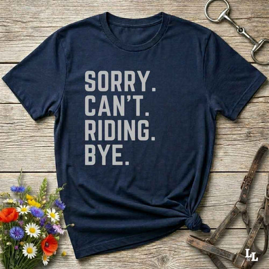 This “Sorry Can’t. Riding. Bye.” western typography tee is the perfect gift for horse lovers, trail riders, and anyone living the cowboy or cowgirl lifestyle. Made from premium Gildan 64000 cotton, it's unisex and available in 8 colors to match your cowboy core aesthetic. Whether you're off to a rodeo, riding horses, or just showing off your rustic humor, this bold minimalist horse quote shirt delivers personality and comfort. Great for birthdays, western lovers, and equestrian fashion fans.