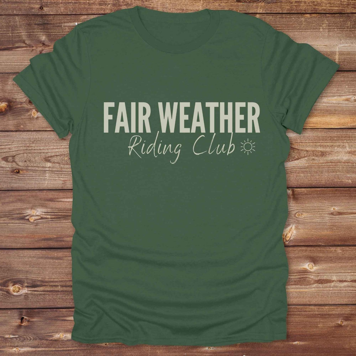"Fair Weather Riding Club” tee brings western charm and playful equestrian humor together in a bold design that speaks to cowboys and cowgirls alike. erfect for horse lovers who only ride in sunshine. Featuring clean typography and a cute sun icon, it’s the ultimate cowboy core essential for rodeo days, trail rides, or just lounging in the barn. Whether it’s for yourself or as a gift for a fellow rider, this western quote tee adds a sunny twist to any rustic outfit. must have for any modern day trailblazer.