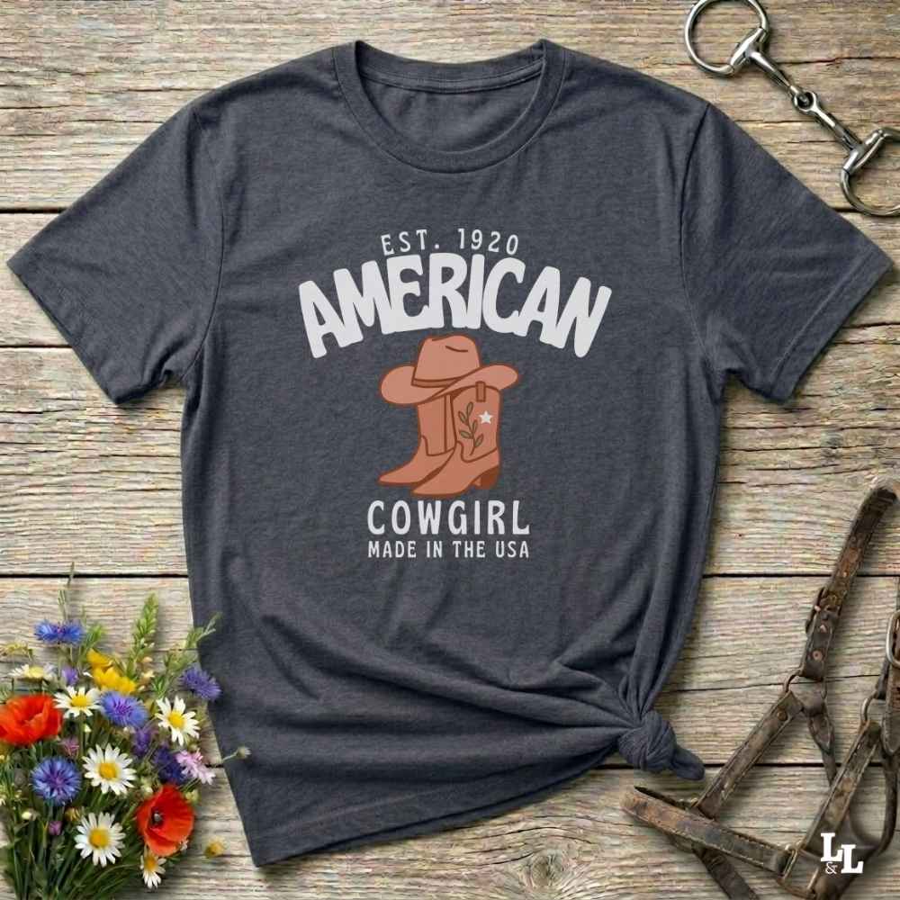 This American Cowgirl T-Shirt is the perfect mix of bold western pride and boho rodeo style. Featuring a rustic boot and hat graphic, it's made for country girls who live for rodeo season and horse rides. It’s a statement piece for cowgirls, country lovers, and western fashion fans alike. Whether you’re gifting it for a birthday or styling it for your next state fair, this tee brings serious cowboy core energy to your closet.  A must have for horse lovers.
