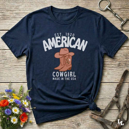 This American Cowgirl T-Shirt is the perfect mix of bold western pride and boho rodeo style. Featuring a rustic boot and hat graphic, it's made for country girls who live for rodeo season and horse rides. It’s a statement piece for cowgirls, country lovers, and western fashion fans alike. Whether you’re gifting it for a birthday or styling it for your next state fair, this tee brings serious cowboy core energy to your closet.  A must have for horse lovers.