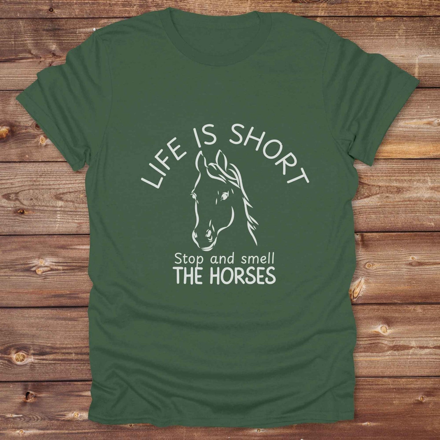 Life is short stop and smell the horses tee. perfect for rodeo fans, horse moms, country girls, and anyone who embraces equestrian life. Whether you're mucking stalls, trail riding, or hitting the local country fair, this rustic shirt makes a fun and relatable statement. It’s the ideal gift for birthdays, holidays, or spontaneous barn day laughs.