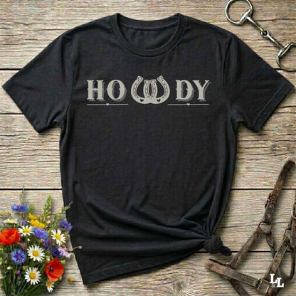 Say “Howdy” in true western style with this rustic horseshoe tee designed for cowboys, cowgirls, and horse lovers alike. Featuring a bold western font and a double horseshoe “W,” this shirt blends southern charm with modern rodeo flair. It's perfect for birthdays, rodeo weekends, country fairs, or just everyday ranch life. Whether you're a rancher, rider, or rural rebel, this shirt adds a little yeehaw to your wardrobe.