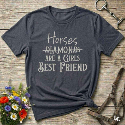 Horses Are a Girl’s Best Friend” gray tee from Lasso and Loom is the perfect blend of sass and saddle ready style. Featuring a rustic hand lettered graphic with the word Diamonds cheekily crossed out, this cowgirl shirt celebrates equestrian passion in the most fashionable way. Ideal as a gift for horse lovers, western girls, and rural soul sisters. Whether you're trail riding, shopping small, or posting from the paddock, this shirt says what every horse girl already knows, diamonds don’t ride.