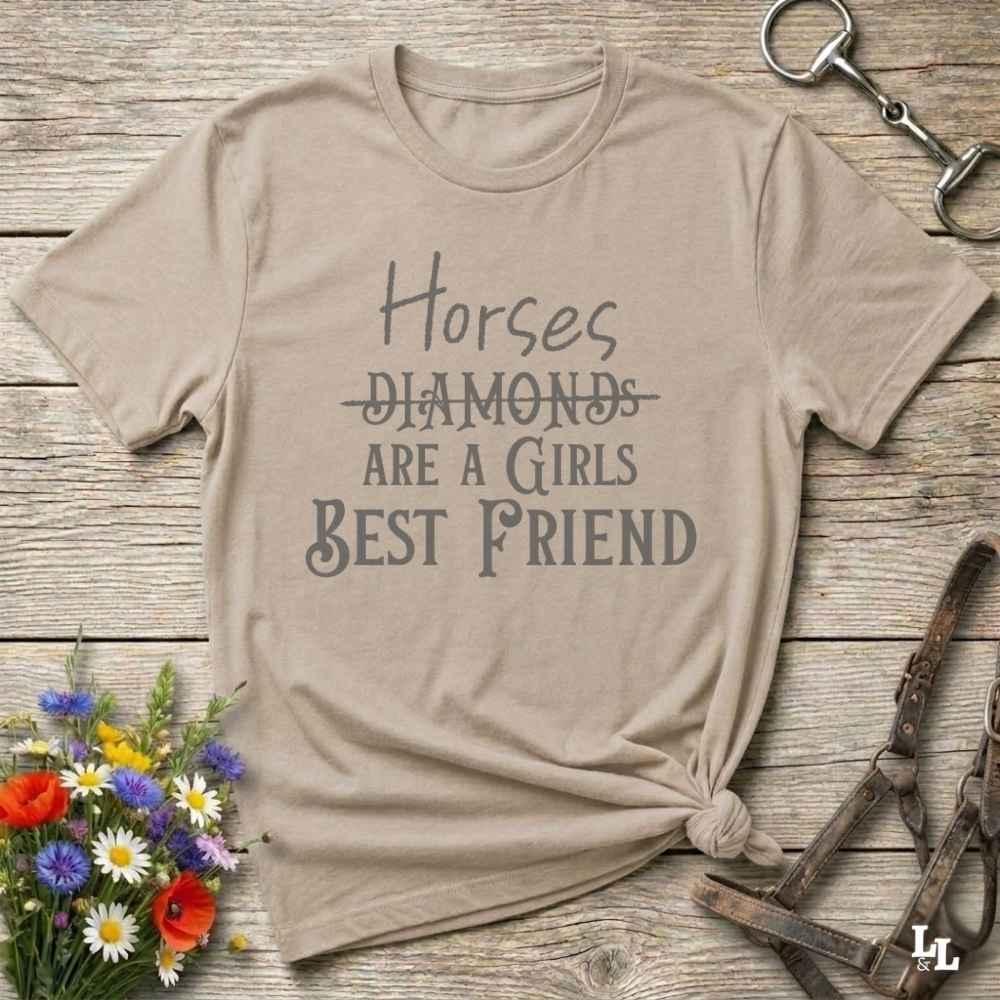 Horses Are a Girl’s Best Friend” beige tee from Lasso and Loom is the perfect blend of sass and saddle ready style. Featuring a rustic hand lettered graphic with the word Diamonds cheekily crossed out, this cowgirl shirt celebrates equestrian passion in the most fashionable way. Ideal as a gift for horse lovers, western girls, and rural soul sisters. Whether you're trail riding, shopping small, or posting from the paddock, this shirt says what every horse girl already knows, diamonds don’t ride.