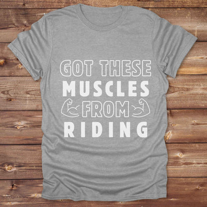 “Got These Muscles from Riding” western t-shirt is perfect for cowgirls, cowboys, horse lovers, and rodeo fans who live strong without stepping in a gym. Designed for equestrians and rural riders who know their strength comes from the saddle, this funny and bold graphic tee is a conversation starter at any barn, rodeo, or Western event. Makes a great gift for horseback riders, trainers, or country girls who work hard and flex harder.