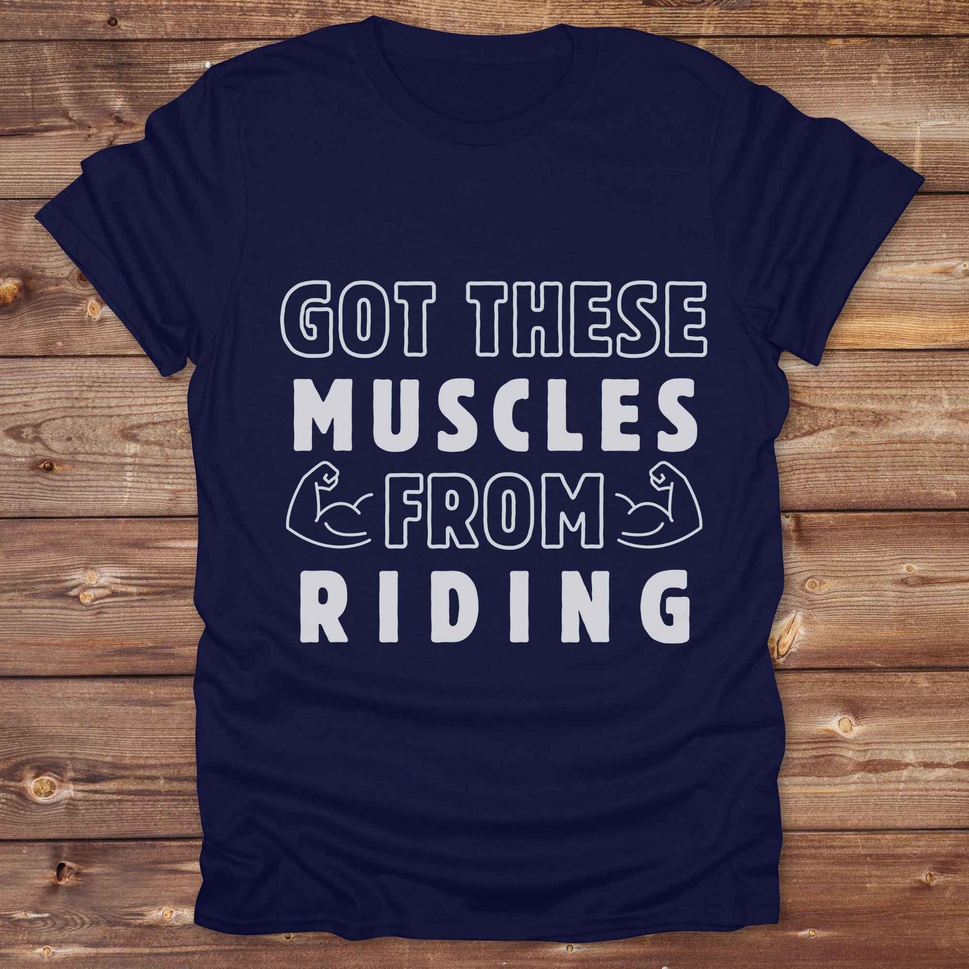 “Got These Muscles from Riding” western t-shirt is perfect for cowgirls, cowboys, horse lovers, and rodeo fans who live strong without stepping in a gym. Designed for equestrians and rural riders who know their strength comes from the saddle, this funny and bold graphic tee is a conversation starter at any barn, rodeo, or Western event. Makes a great gift for horseback riders, trainers, or country girls who work hard and flex harder.