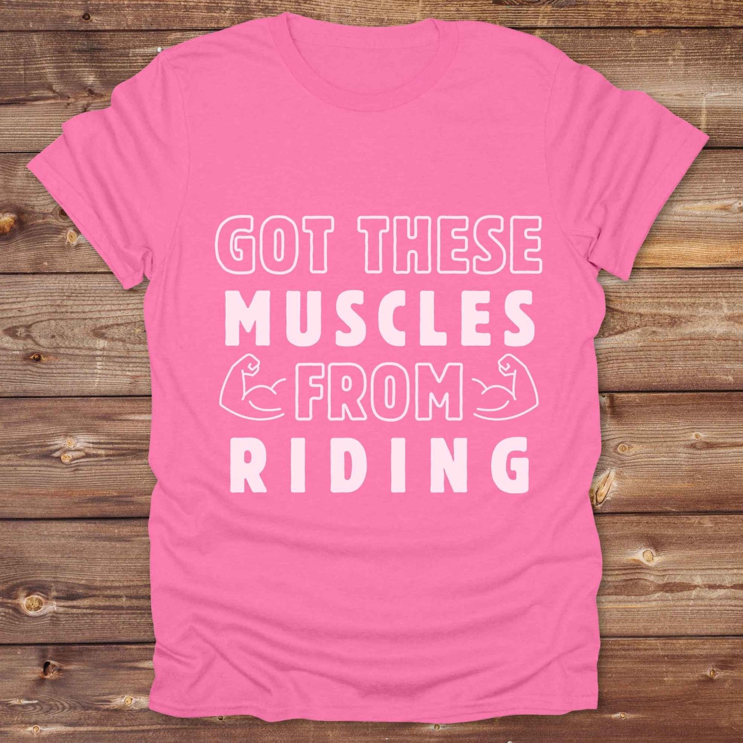 “Got These Muscles from Riding” western t-shirt is perfect for cowgirls, cowboys, horse lovers, and rodeo fans who live strong without stepping in a gym. Designed for equestrians and rural riders who know their strength comes from the saddle, this funny and bold graphic tee is a conversation starter at any barn, rodeo, or Western event. Makes a great gift for horseback riders, trainers, or country girls who work hard and flex harder.
