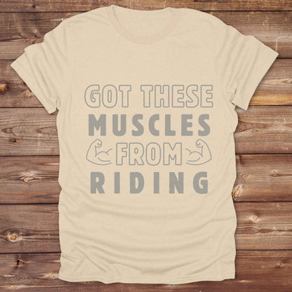 “Got These Muscles from Riding” western t-shirt is perfect for cowgirls, cowboys, horse lovers, and rodeo fans who live strong without stepping in a gym. Designed for equestrians and rural riders who know their strength comes from the saddle, this funny and bold graphic tee is a conversation starter at any barn, rodeo, or Western event. Makes a great gift for horseback riders, trainers, or country girls who work hard and flex harder.